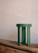 Minimalist Juntowd Trio Stool used as a compact side table in a modern living room setting.